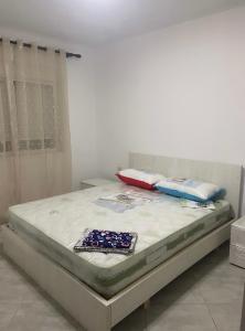 a bed in a room with two pillows on it at Apartment Jon 1 in Vlorë