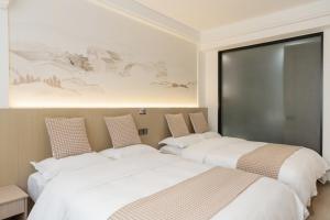 Uma cama ou camas num quarto em 乌镇闲情逸致精品民宿