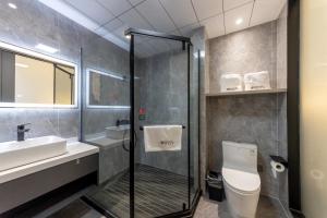 a bathroom with a shower and a toilet and a sink at 乌镇闲情逸致精品民宿 in Wujiaqiao