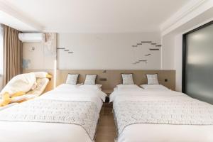 Uma cama ou camas num quarto em 乌镇闲情逸致精品民宿