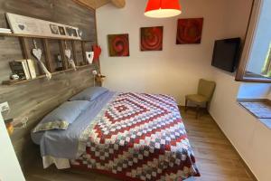 a bedroom with a bed with a quilt on it at Casa vacanze Santo Stefano di Sessanio in Santo Stefano di Sessanio