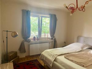 a bedroom with a bed and a window with blue curtains at Nett in Mettmann in Mettmann