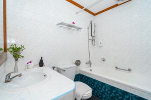 a bathroom with a tub and a toilet and a sink at Patong Social Hotel & Restaurant, Patong Beach in Patong Beach +41 photos