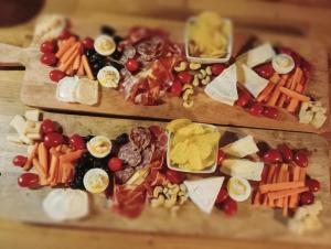 two cutting boards filled with different types of food at La Ferme de Plénoise Chambre & Table d'hôtes in Fricambault +45 photos