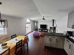 a kitchen and a dining room with a table and a dining room at EC Lodging in Yellowknife