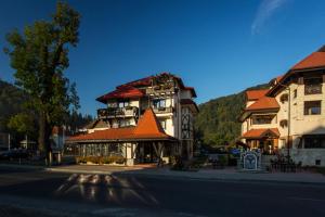 a building on the side of a street next to a building at Casa Din Bran - Inn Center in Bran