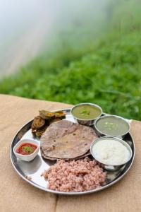 une assiette de nourriture avec différents types d'aliments sur une table dans l'établissement Rumuk Boutique Resort - Offbeat escape, à Dhanaulti