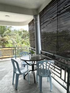 a table and chairs sitting on a balcony at Baiduri Homestay in Kota Tinggi +3 photos