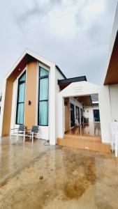 un edificio con sedie e tavoli di fronte ad esso di Love Mountain Pool Villa ประจันตคาม ปราจีนบุรี a Ban Ko Ta Moi