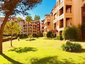a park in front of a large apartment building at Alcaudón, Isla Canela - By AC REAL in Isla Canela