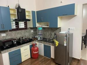 a kitchen with blue cabinets and a fire hydrant at Quite and peaceful in Perumanseri