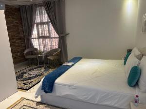 a bedroom with a large bed with a window at Mountain village house in Ḑab‘ah +95 photos