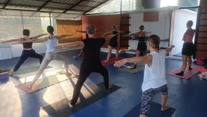 a group of people in a yoga class at tippys beach resort in Kovalam