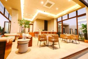a large living room with a table and chairs at TANA Beach Villas in Lian