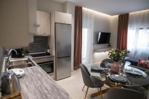 a kitchen and living room with a table and a kitchen and a kitchen at KLELIA Luxury Apartment in Alexandroupoli