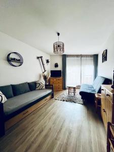 un salon avec un canapé et une table dans l'établissement Le Sappey-Pied des pistes-Parking gratuit, à Les Deux Alpes