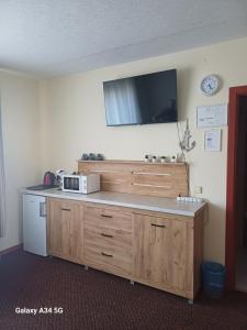 a kitchen with a counter with a microwave on the wall at Morena in Klaipėda