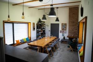 a dining room with a large wooden table and chairs at Casa VIDA in Neštin +31 photos