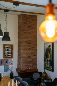 a living room with a brick wall at Casa VIDA in Neštin