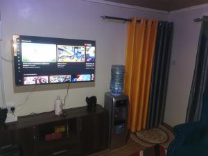a flat screen tv on a wall in a living room at Micasa Homes BnB D6 in Limuru