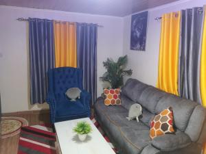 a living room with a couch and a table at Micasa Homes BnB D6 in Limuru +1 photo