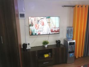a flat screen tv hanging on a wall at Micasa Homes BnB D6 in Limuru
