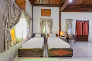 Postel nebo postele na pokoji v ubytování Pondok Gajah Hotel + 37 fotografií