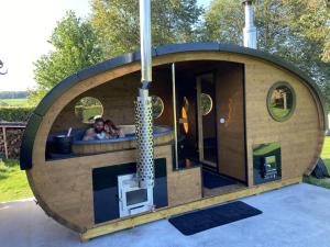 a small circular building with two people in it at La Milardière Chambres d'Hôtes B&B in Theux