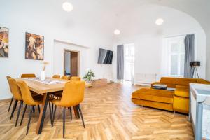 a living room with a table and chairs and a couch at Luxapart II Beautiful Views with Breakfast option in Košice