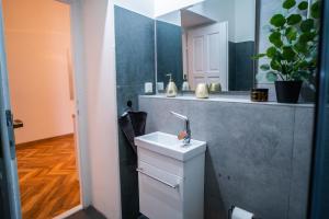 a bathroom with a sink and a mirror at Luxapart II Beautiful Views with Breakfast in Košice +45 photos