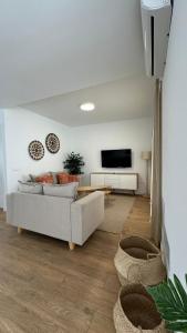 a living room with a couch and a flat screen tv at Serena Holiday Homes by LIVVO in Playa Blanca