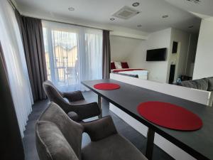 a living room with a couch and a table and chairs at NEU! Ihr Ticket ins Blaue - Rooftop-Ferienwohnung am Kurpark Bad Kreuznach in Bad Kreuznach