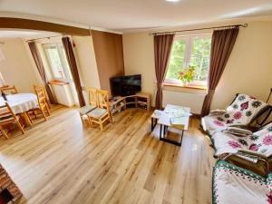 a living room with a couch and a table at Zawoja Domek 1895 - Sauna i Bania in Zawoja +33 photos
