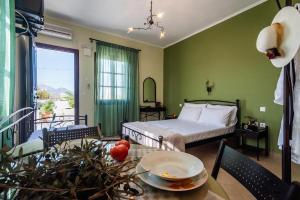 a bedroom with a bed and a table with a dining room at Firiki Studios in Zefiría