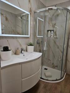 a white bathroom with a shower and a sink at Luxury Suite, Villa Joy Verona , Exclusive Romantic Luxury Suite with Jacuzzi, near Verona Center in Verona