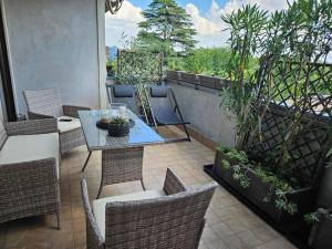 a patio with a table and chairs and plants at Luxury Suite, Villa Joy Verona , Exclusive Romantic Luxury Suite with Jacuzzi, near Verona Center in Verona