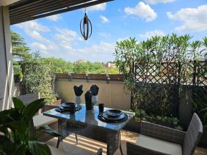 a patio with a table and chairs on a balcony at Luxury Suite, Villa Joy Verona , Exclusive Romantic Luxury Suite with Jacuzzi, near Verona Center in Verona +13 photos