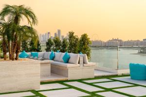 a patio with a couch and a view of the city at C Central Hotel and Resort The Palm in Dubai