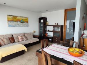 a living room with a table and a couch at Perfect Sea View in Vila do Conde