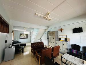 a room with a waiting room with chairs and a piano at Patone Hostel in Phra Nakhon Si Ayutthaya