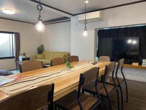 a conference room with a large wooden table and chairs at NorthHisath-Susukino in Sapporo
