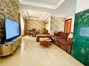 a living room with a couch and a flat screen tv at villa in heart of hurgada in Hurghada