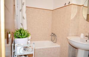 a bathroom with a tub and a sink and a toilet at CasArancio 6 in San Paolo Albanese
