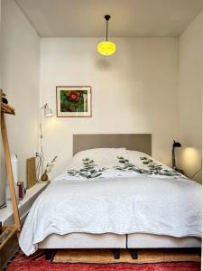 a bedroom with a bed with a white comforter at Leiden City Centre Canal View or Terrace View Apartments in Leiden +36 photos