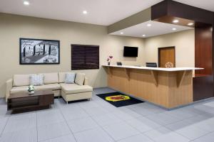 a waiting room with a couch and a reception desk at Super 8 by Wyndham St. Clairsville OH/Wheeling WV Area in Saint Clairsville