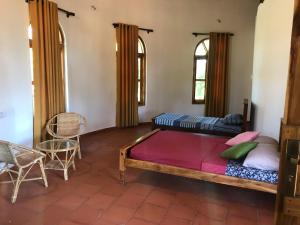 Ένα ή περισσότερα κρεβάτια σε δωμάτιο στο Banyan Beach Cottage SRI LANKA