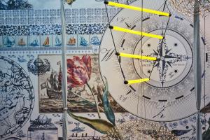 a clock on the side of a wall with drawings at Andaz Amsterdam, Prinsengracht, By Hyatt in Amsterdam