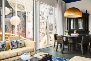 a living room with a couch and a table at Andaz Amsterdam, Prinsengracht, By Hyatt in Amsterdam