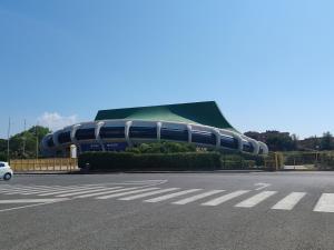 a large building with a road in front of it at OSTIA HOME in Lido di Ostia