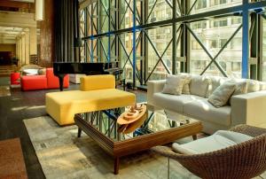 a living room with a couch and a piano at Radisson Montevideo Victoria Plaza Hotel in Montevideo